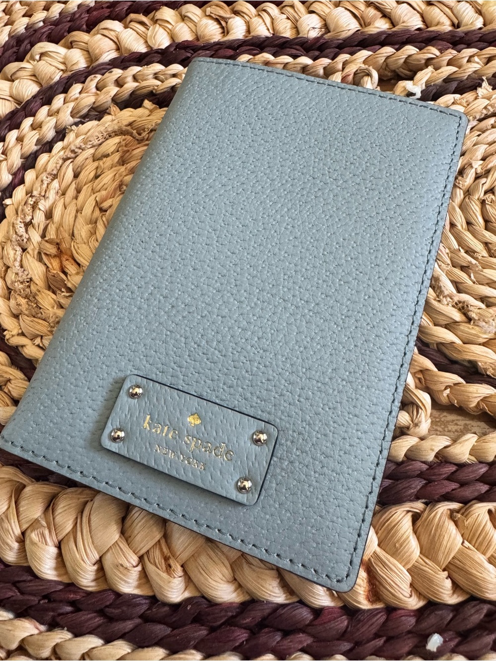kate spade light blue pebbled leather passport cover with gold logo